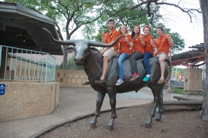 5 UT students sitting on top of Longhorn statue