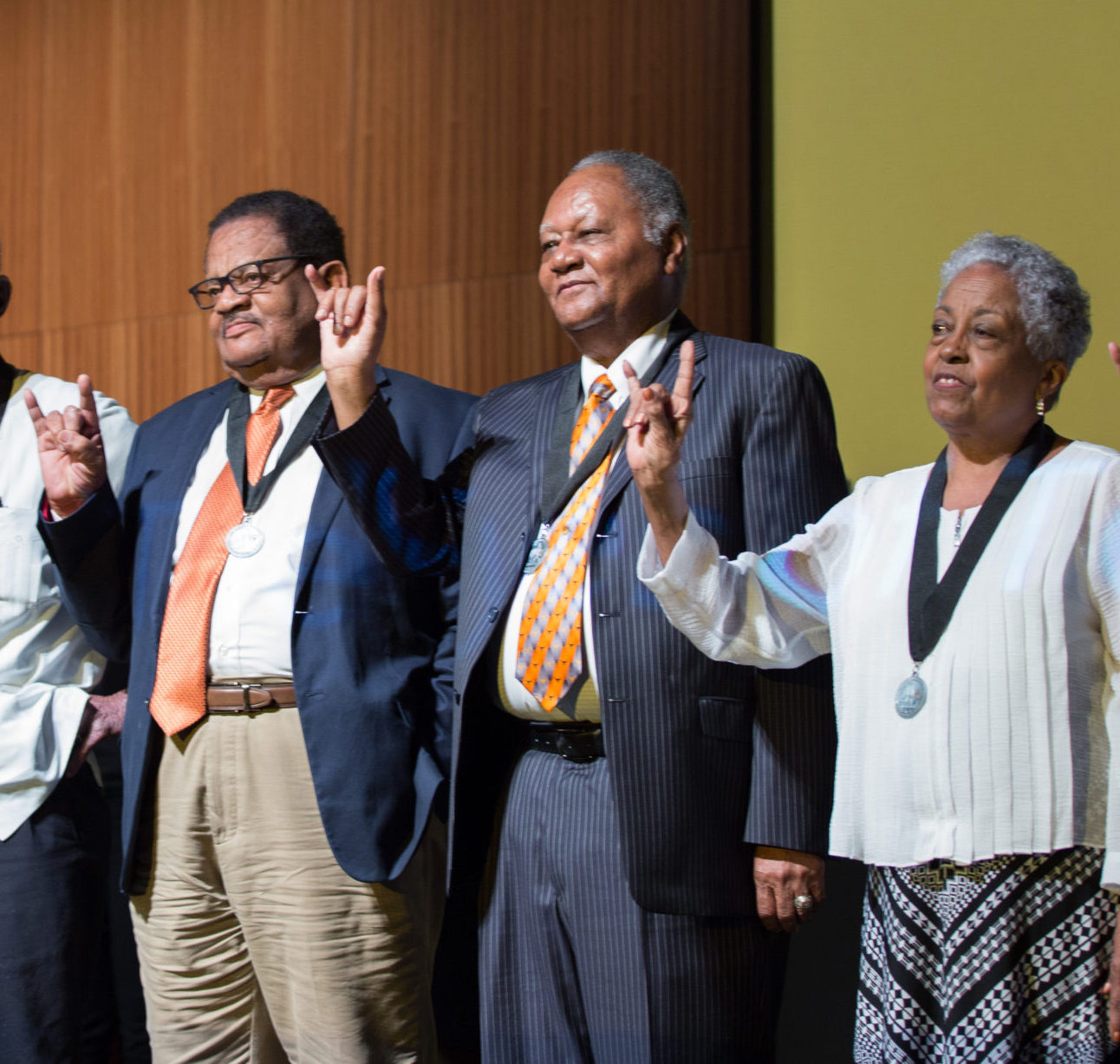 Willie C. Jordan Jr. (far left) raises his horns with a group of Precursors during the 60th anniversary celebration for the first Black undergraduates to enter UT Austin in 1956.